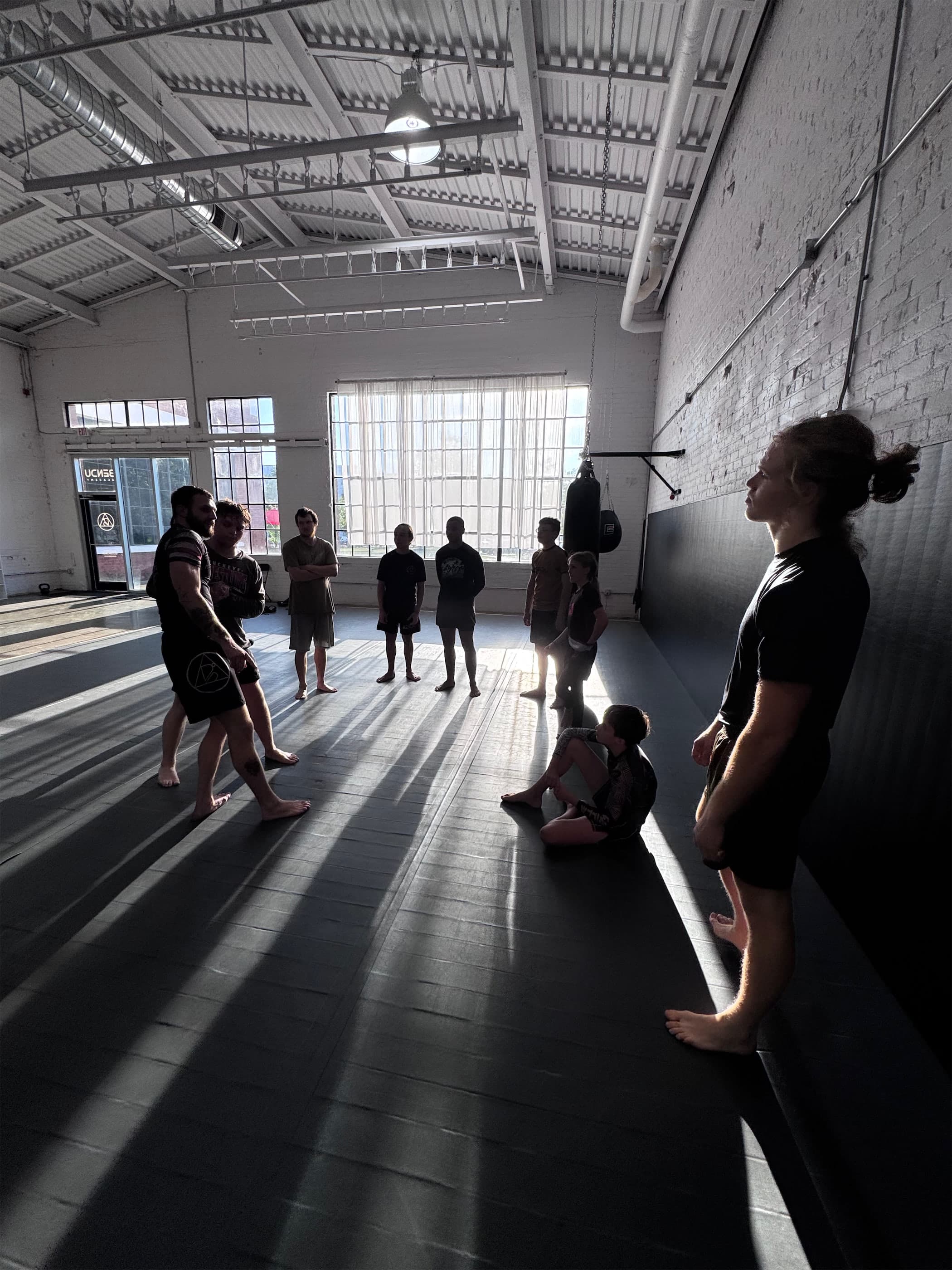 Students standing on the mats before class at Bendu Academy